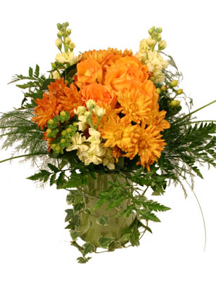 Thanksgiving Feast - Orange Roses Bouquet - This gorgeous display of bright orange roses paired with bronze colored chrysanthemums and berries is a great November bouquet. It works fantastically on your dinner table as the focal point of your Thanksgiving feast, but works just as well as a wonderful gift for a loved one who cannot be with you for your special Thanksgiving celebration. 
The pictured vase is not included in the price, but can be purchased during checkout for $10.99. The bouquet works especially well for this exceptional moss green vase. For best results, cut the stems to a length of 5 inches from the wire tie. Put the bouquet in the vase, wrap the ivy around the shape of the vase and it will make for a wonderful centerpiece. 

Order your Thanksgiving bouquet by 1:00 EST for FedEx next day delivery Tuesday through Saturday. Other pretty vases and special items are available during checkout. Overnight delivery Tuesday - Friday is $10.99, Saturday is $19.99. Place an order now to send flowers and send a touch of modern elegance.<br><br>Code:10021-9470-10021-0000082890